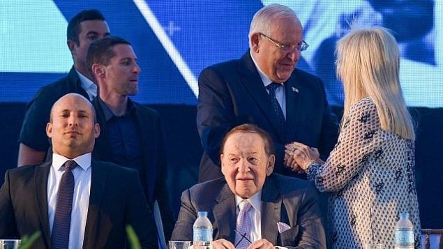 رجل الأعمال والمستثمر الأمريكي شيلدون أديلسون (الجالس من اليمين)، وزوجته ميريام مع رئيس الدولة رؤوفين ريفلين (الذي يقف في الوسط) ووزير التربية والتعليم نفتالي بينيت (من اليسار) في مراسم افتتاح كلية الطب في جامعة أريئيل بالشفة الغربية، 19 أغسطس، 2018. (Ben Dori/Flash90)