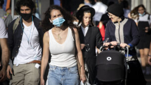 أشخاص يرتدون أقنعة يسيرون في وسط مدينة القدس، خلال إغلاق على مستوى البلاد، 15 أكتوبر 2020 (Olivier Fitoussi / Flash90)