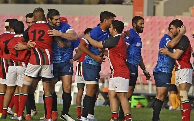 لاعبو منتخبي كرة الرغبي الإسرائيليون (الأزرق) والإماراتيون يحيون بعضهم البعض بعد أول مباراة ودية جمعت المنتخبين في دبي، 19 مارس، 2021. (Karim SAHIB/AFP)