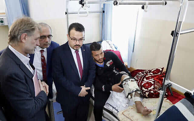 الدكتور جيرالد روكينشاب، مدير منظمة الصحة العالمية في الأراضي الفلسطينية (يسار) ، يستمع لأطباء فلسطينيين خلال جولة في مركز إعادة بناء الأطراف في مستشفى ناصر في مدينة خان يونس، جنوب قطاع غزة، 5 مارس، 2020. (Adel Hana/AP)