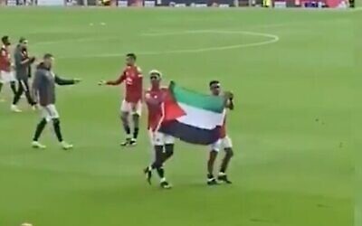 لقطة شاشة من مقطع فيديو للاعبي مانشستر يونايتد يحملان العلم الفلسطيني بعد مباراة، 17 مايو، 2021. (Twitter)