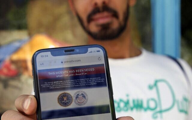 رجل إيراني يظهر على هاتفه المحمول بيانا يعلن فيه أن الموقع الإلكتروني لمحطة ’برس تي في’ التلفزيونية الإيرانية الناطقة بالإنجليزية "تم الاستيلاء عليه من قبل حكومة الولايات المتحدة" ، في العاصمة طهران في 23 يونيو، 2021.(Photo by - / AFP) رجل إيراني يظهر على هاتفه المحمول بيانا يعلن فيه أن الموقع الإلكتروني لمحطة ’برس تي في’ التلفزيونية الإيرانية الناطقة بالإنجليزية "تم الاستيلاء عليه من قبل حكومة الولايات المتحدة" ، في العاصمة طهران في 23 يونيو، 2021.(Photo by - / AFP)