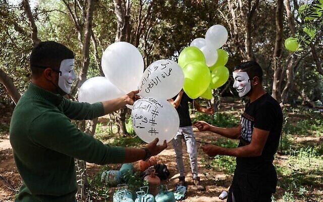 Masked Palestinian followers of the Hamas movement near Beit Lahia in the Gaza Strip, prepare to fly incendiary balloons across the northern border toward Israel, on May 8, 2021, a day after al-Quds (Jerusalem) Day. - Israel braced for more protests today after clashes at Jerusalem's flashpoint Al-Aqsa Mosque compound wounded more than 200 people and as the US, EU and regional powers urged calm after days of escalating violence.
The unrest came as Iran and its allies around the world marked Al-Quds Day, an annual show of solidarity with the Palestinians. (Photo by MOHAMMED ABED / AFP)