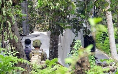 جنود فلبينيون يقفون بالقرب من حطام طائرة نقل تابعة للقوات الجوية الفلبينية من طراز C-130 ، والتي تحطمت في 4 يوليو، مما أسفر عن سقوط 50 قتيلا، في بلدة جولو بمقاطعة سولو بالقرب من جزيرة مينداناو  بجنوب البلاد،  5 يوليو، 2021.  (Nickee BUTLANGAN / AFP)