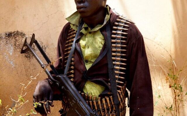 (FILES) In this file photograph taken on February 14, 2019, a member of SPLA-IO stands guard as peace talks take place in Pageri, Imatong State, South Sudan. - Deadly fighting erupted on August 7, 2021, between rival factions of South Sudan Vice President Riek Machar's SPLA-IO, his military spokesman said in a statement. The clashes erupted after Machar's rivals declared this week they had deposed him as the head of the party and its military forces. (Photo by ALEX MCBRIDE / AFP)
