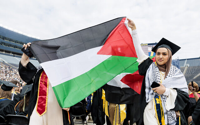 متظاهرون مؤيدون للفلسطينيين يتظاهرون خلال حفل تخرج جامعة ميشيغن لربيع 2024 في استاد ميشيغان في آن أربور، ميشيغان، 4 مايو، 2024. (Jacob Hamilton/Ann Arbor News via AP) متظاهرون مؤيدون للفلسطينيين يتظاهرون خلال حفل تخرج جامعة ميشيغن لربيع 2024 في استاد ميشيغان في آن أربور، ميشيغان، 4 مايو، 2024. (Jacob Hamilton/Ann Arbor News via AP)