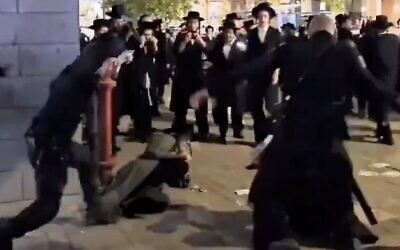 فيديو يظهر عناصر الشرطة يستخدمون هراواتهم لضرب متظاهرين حريديم في مركز مجتمعي في بيت شيمش، 23 سبتمبر 2024. (X video screenshot; used in accordance with Clause 27a of the Copyright Law)