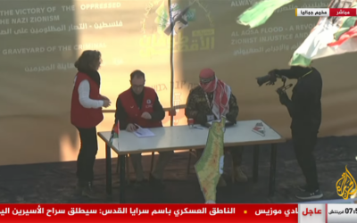 ممثلو الصليب الأحمر على منصة أقامتها حماس في جباليا شمال غزة لتوقيع وثائق إطلاق سراح الجندية المحتجزة أغام بيرغر في 30 يناير 2025 (Screen grab/Al Jazeera)