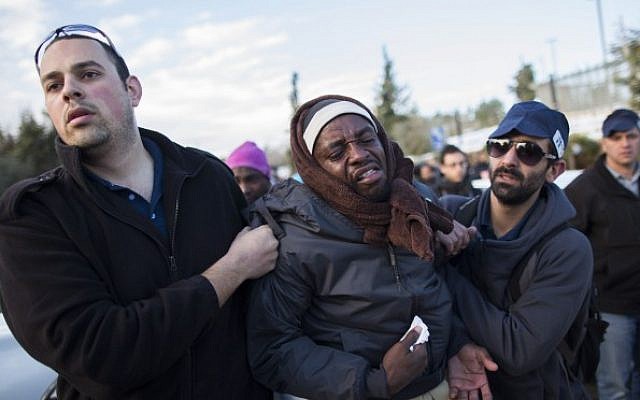 Sudanese refugee get arrested by immigration police in front of the Knesset after marching towards Jerusalem from the south in protest of the new "Holot" detention camp for illegal migrants, on Monday, December 17, 2013 (photo credit: Yonatan Sindel/Flash90)
