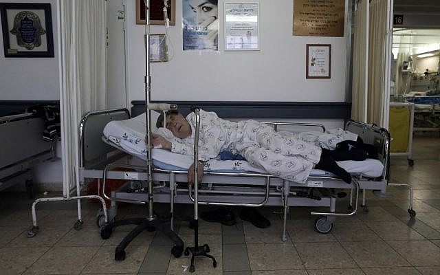 Illustrative photo of a patient kept in a corridor dur to overcrowding at a hospital. (photo credit: Tsafrir Abayov/Flash90)