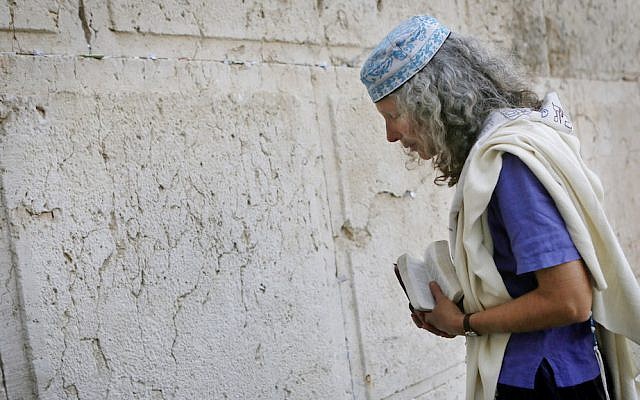 Religious Jewish women which are part of the Women of the Wall organization wear tfillin (prayer shawls) and tallit as they read from the Torah and pray at Robinson's Arch,  near the Western Wall in Jerusalem. The WOW organizes women's prayer groups at the Western Wall at the start of every new Jewish month (Rosh Hodesh). Jewish ultra orthodox communities oppose women's singing in the presence of men, reading from the Torah, and wearing the ritual garments and objects traditionally associated with men. March 12, 2013. Photo by Miriam Alster/FLASH90