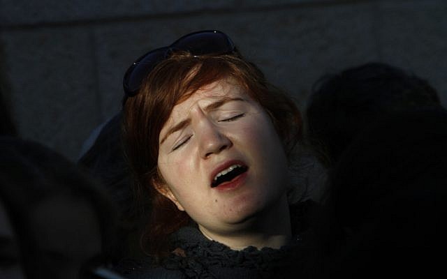 A Religious Jewish woman attends a prayer organized by the "Women of the Wall" at the Western Wall in Jerusalem. The WOW organizes women's prayer groups at the Western Wall at the start of every new Jewish month (Rosh Hodesh). Jewish ultra orthodox communities oppose women's singing in the presence of men, reading from the Torah, and wearing the ritual garments and objects traditionally associated with men. December 08, 2010. Photo by Miriam Alster/FLASH90  *** Local Caption ***