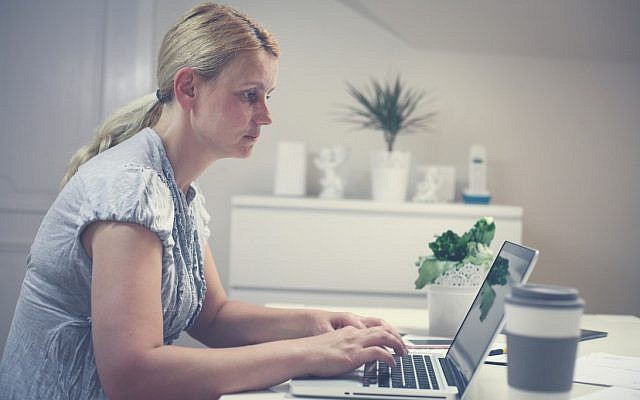 Illustrative photo of a woman at her computer (iStock/Liderina)