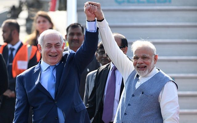 Indian Prime Minister Narendra Modi, right, and Prime Minister  Benjamin Netanyahu pose for photographers after the Israeli leader arrived at the Air Force Station in New Delhi January 14, 2018. (Prakash Singh/AFP)