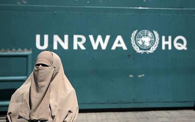 Illustrative: A Palestinian stands outside the UN Relief and Works Agency (UNRWA) headquarters in Gaza City, Sunday, Aug. 16, 2015. (AP Photo/Khalil Hamra)