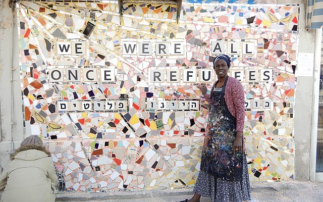 Illustrative: Lina, an asylum seeker from Sudan, with the finished mural on Rothschild Boulevard in Tel Aviv on February 21, 2018. (Melanie Lidman/Times of Israel)