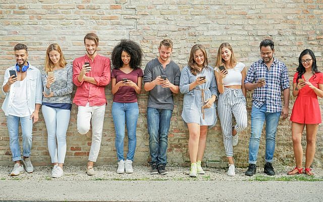 Illustrative: Millennials using cell phones. (via iStock)