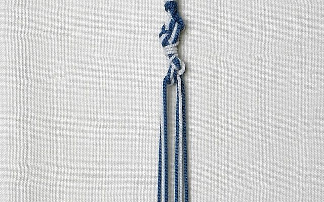 Illustrative: Tzitzit tassels with threads dyed in tekhelet blue produced from Murex trunculus snails (courtesy of Ptil Tekhelet/Eugene Weisberg)