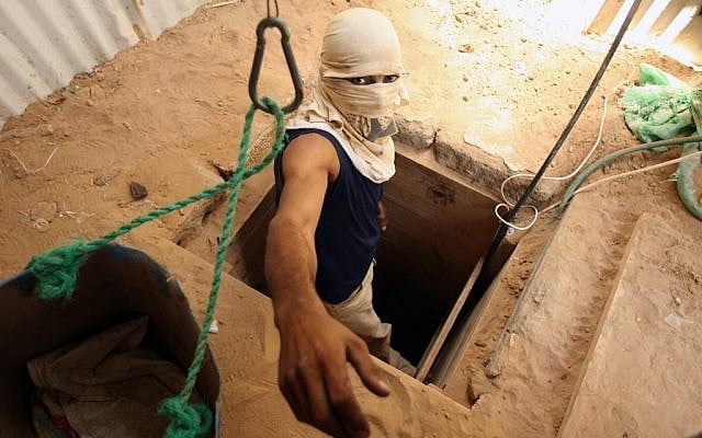 A masked man emerges from a tunnel linking the Gaza Strip to Egypt (photo credit: Abed Rahim Khatib /Flash90)
