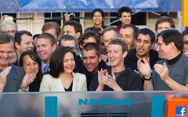 Illustrative. Facebook founder, chairman, and CEO Mark Zuckerberg, center, applauds at the opening bell of the Nasdaq stock market, July 6, 2018. (AP via Facebook) Illustrative. Facebook founder, chairman, and CEO Mark Zuckerberg, center, applauds at the opening bell of the Nasdaq stock market, July 6, 2018. (AP via Facebook)