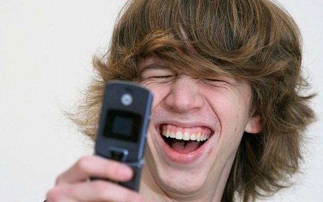 Cellphone fun (Photo credit: Moshe Shai/FLASH90)
