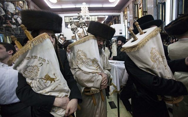 Ultra-Orthodox Jewish men carry Torah scrolls as they dance during Simchat Torah celebrations in Jerusalem's Mea Shearim neighbourhood October 8 (photo credit: Yonatan Sindel/Flash90)