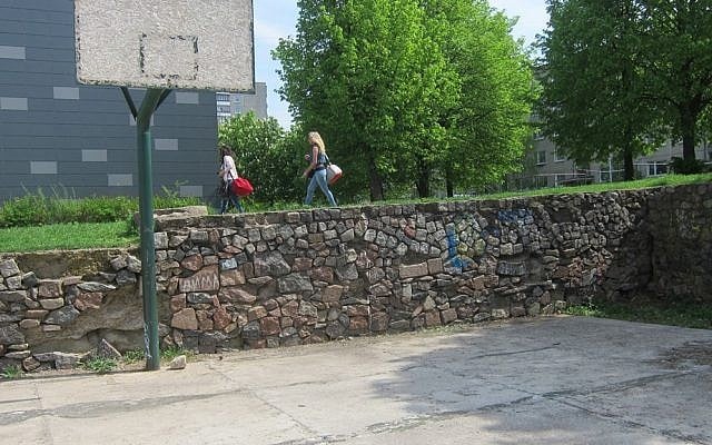 Jewish gravestone were used to build this school basketball court in Vilna, Lithuania. Now the evidence has been removed. (photo: DefendingHistory.com)