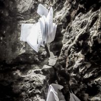 Prayers and holy petitions wedged into stones at the underground tomb of Mishnaic-era scholar, R' Yehuda Bar Ilai, near Safed, Israel.