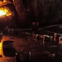 A memorial candle flickers alongside tombs in the underground tomb of Mishnaic-era scholar, R' Yehuda Bar Ilai, near Safed, Israel.