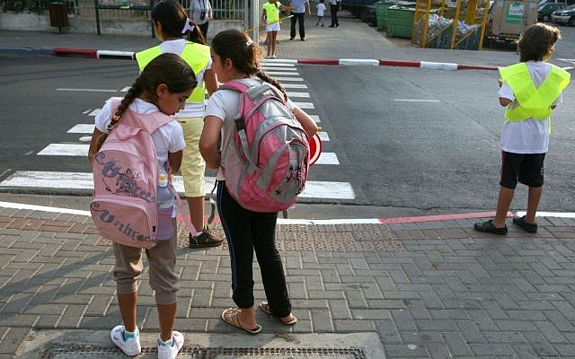 Illustrative: Schoolchildren waiting to cross a street. (Liron Almog/Flash90)