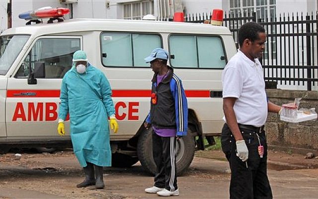 Health workers outside Connaught Hospital after the arrival of a patient with symptoms of the Ebola virus in the city of Freetown, Sierra Leone, August 4, 2014. (photo credit: AP/Youssouf Bah) Health workers outside Connaught Hospital after the arrival of a patient with symptoms of the Ebola virus in the city of Freetown, Sierra Leone, August 4, 2014. (photo credit: AP/Youssouf Bah)