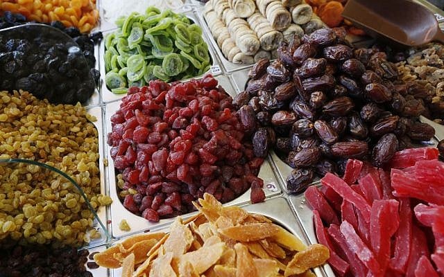 Overflowing containers of dried fruits -- from near and far -- at Jerusalem's Mahane Yehuda market (photo credit: Miriam Alster/Flash 90) Overflowing containers of dried fruits -- from near and far -- at Jerusalem's Mahane Yehuda market (photo credit: Miriam Alster/Flash 90)