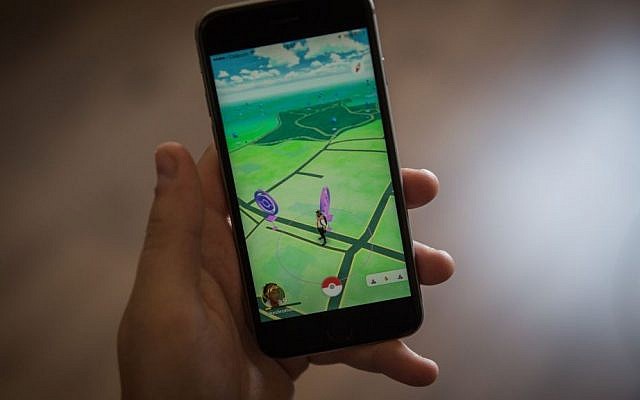Illustrative photo of a young Israeli man playing Pokémon Go on his iPhone, on July 28, 2016. (Hadas Parush/Flash90)