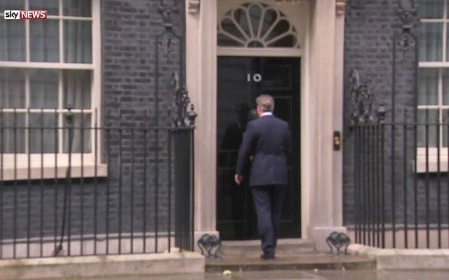 Outgoing British Prime Minister David Cameron, humming to himself, enters his official residence at 10 Downing Street on July 11, 2016 after announcing he would step down two days later. (YouTube screen capture)