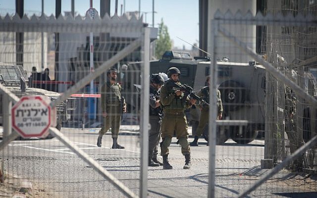 Illustrative. Israeli security forces guard at the Qalandiya Checkpoint near Ramallah, on July 26, 2016. (Flash90) Illustrative. Israeli security forces guard at the Qalandiya Checkpoint near Ramallah, on July 26, 2016. (Flash90)