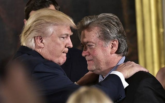 US President Donald Trump, left, congratulates then senior counselor to the president Stephen Bannon during the swearing-in of senior staff in the East Room of the White House on January 22, 2017 in Washington, DC. (AFP/Mandel Ngan)