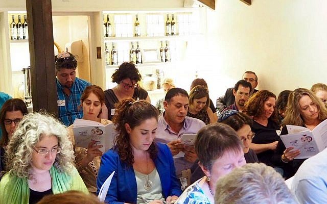 Illustrative: A group of Israeli Reform rabbis, including Rabbi Tamir Nir (center, purple shirt), read from a festive tractate marking Diaspora-Israel Day on November 13, 2016 in Tel Aviv. (Facebook)