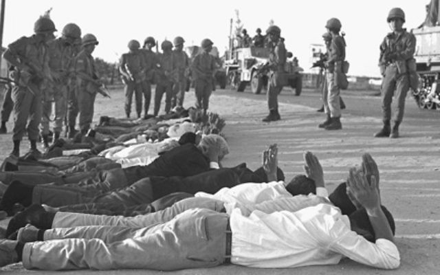 Israeli troops guard captured Egyptian troops and Palestinians at the start of the Six Day War, on June 5, 1967 in Rafah, Gaza Strip. [GALLO/ GETTY]