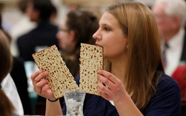 Illustrative: A woman breaks the middle matzah at a model seder on March 11, 2016. (Jaren Wilkey/BYU) Illustrative: A woman breaks the middle matzah at a model seder on March 11, 2016. (Jaren Wilkey/BYU)