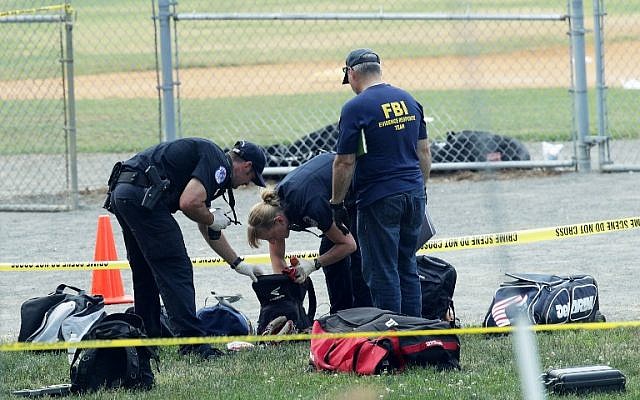 Investigators search the bags that have been left behind at the Eugene Simpson Stadium Park where a shooting took place on June 14, 2017 in Alexandria, Virginia. (Alex Wong/Getty Images/AFP) Investigators search the bags that have been left behind at the Eugene Simpson Stadium Park where a shooting took place on June 14, 2017 in Alexandria, Virginia. (Alex Wong/Getty Images/AFP)