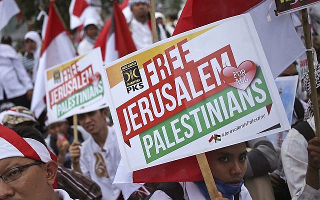 Muslim men hold posters during a rally against US President Donald Trump's decision to recognize Jerusalem as Israel's capital outside the US Embassy in Jakarta, Indonesia, December 10, 2017. (AP Photo/Dita Alangkara) Muslim men hold posters during a rally against US President Donald Trump's decision to recognize Jerusalem as Israel's capital outside the US Embassy in Jakarta, Indonesia, December 10, 2017. (AP Photo/Dita Alangkara)