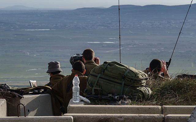 Israeli soldiers survey the border with Syria from a military post in the Golan Heights, following a series of aerial clashes with Syrian and Iranian forces in Syria, on February 10, 2018. (Flash90) Israeli soldiers survey the border with Syria from a military post in the Golan Heights, following a series of aerial clashes with Syrian and Iranian forces in Syria, on February 10, 2018. (Flash90)