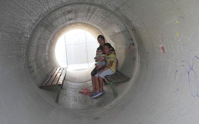 Illustrative: An Israeli family takes cover in a bomb shelter made of a converted concrete pipe during the 2014 Gaza war. (Melanie Lidman/Times of Israel) Illustrative: An Israeli family takes cover in a bomb shelter made of a converted concrete pipe during the 2014 Gaza war. (Melanie Lidman/Times of Israel)