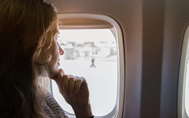 Woman passenger on a plane looking out of the window (via iStock) Woman passenger on a plane looking out of the window (via iStock)