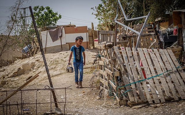 A boy walks through the Bedouin village of Khan al-Ahmar, near the Jerusalem-Dead Sea highway, on April 13, 2018. (Yaniv Nadav/ Flash90) A boy walks through the Bedouin village of Khan al-Ahmar, near the Jerusalem-Dead Sea highway, on April 13, 2018. (Yaniv Nadav/ Flash90)