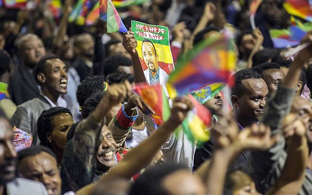 Ethiopians wave during an event celebrating reconciliation with Eritrea in Addis Ababa, Sunday July 15, 2018. (AP photo Mulugeta Ayene) Ethiopians wave during an event celebrating reconciliation with Eritrea in Addis Ababa, Sunday July 15, 2018. (AP photo Mulugeta Ayene)