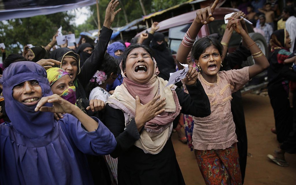 Rohingya women cry and shout slogans during a protest rally to commemorate the first anniversary of Myanmar army's crackdown on Rohingya Muslims, Kutupalong refugee camp in Bangladesh, Saturday, Aug. 25, 2018. (AP Photo/Altaf Qadri) Rohingya women cry and shout slogans during a protest rally to commemorate the first anniversary of Myanmar army's crackdown on Rohingya Muslims, Kutupalong refugee camp in Bangladesh, Saturday, Aug. 25, 2018. (AP Photo/Altaf Qadri)