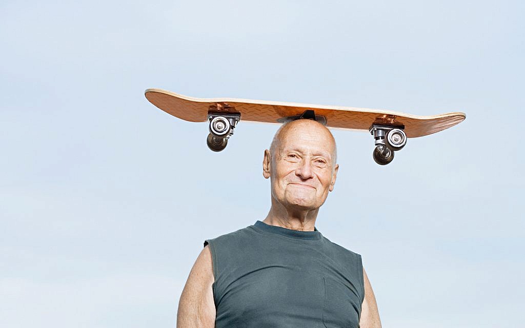 Illustrative: Man with skateboard on his head (via iStock)