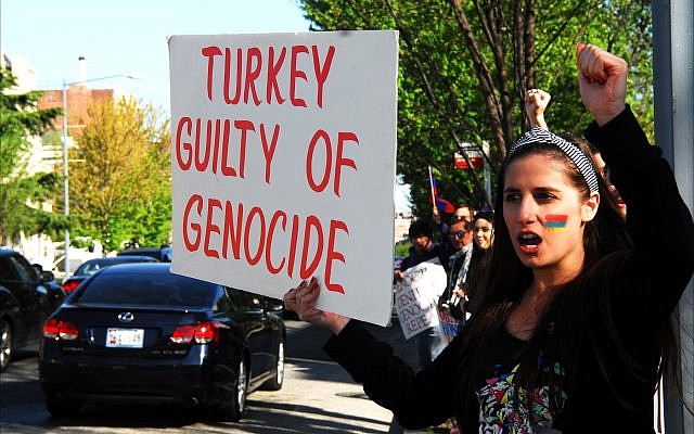 Armenian woman shouts slogans at passersby along Massachusetts Avenue in front of the Turkish Embassy in Washington, D.C., as part of 2015 protests marking the 100th anniversary of the massacre of 1.5 million Armenians. (Larry Luxner) Armenian woman shouts slogans at passersby along Massachusetts Avenue in front of the Turkish Embassy in Washington, D.C., as part of 2015 protests marking the 100th anniversary of the massacre of 1.5 million Armenians. (Larry Luxner)