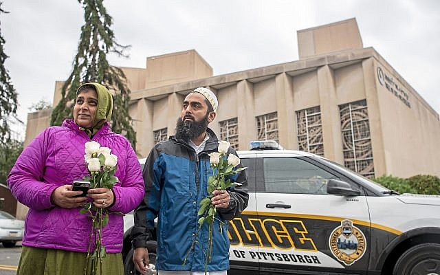 Samina Mohamedali, left, and her husband Kutub Ganiwalla, members of the Dawoodi Bohra Muslim community, both of North Hills, prepare to place flowers on a memorial in front of the Tree of Life Congregation, Sunday, Oct. 28, 2018, in Squirrel Hill neighborhood of Pittsburgh. (Alexandra Wimley/Pittsburgh Post-Gazette via AP via Jewish News) Samina Mohamedali, left, and her husband Kutub Ganiwalla, members of the Dawoodi Bohra Muslim community, both of North Hills, prepare to place flowers on a memorial in front of the Tree of Life Congregation, Sunday, Oct. 28, 2018, in Squirrel Hill neighborhood of Pittsburgh. (Alexandra Wimley/Pittsburgh Post-Gazette via AP via Jewish News)